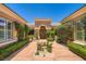 Welcoming front entrance with manicured landscaping and a stone bench, creating a serene approach at 4719 Riva De Romanza St, Las Vegas, NV 89135