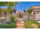 Elegant gated entry with manicured landscaping, flowerpots, and charming details at 4719 Riva De Romanza St, Las Vegas, NV 89135