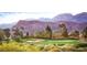 Picturesque golf course against a backdrop of majestic mountains and a tranquil blue sky at 4719 Riva De Romanza St, Las Vegas, NV 89135