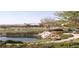 Scenic view of a golf course and water feature surrounded by lush landscaping and mountains in the background at 4719 Riva De Romanza St, Las Vegas, NV 89135