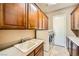 Laundry room with modern washer and dryer, ample storage, and a utility sink at 4719 Riva De Romanza St, Las Vegas, NV 89135