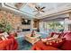 Inviting living room features a stone fireplace, coffered ceilings, and access to a patio at 4719 Riva De Romanza St, Las Vegas, NV 89135