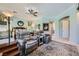Spacious main bedroom with a ceiling fan, decorative wreath, and comfortable seating area at 4719 Riva De Romanza St, Las Vegas, NV 89135