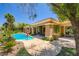 Beautiful backyard featuring a large pool and lush landscaping, perfect for outdoor entertaining at 4719 Riva De Romanza St, Las Vegas, NV 89135
