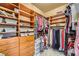 Spacious walk-in closet with custom wood shelving and plenty of room for storage at 4719 Riva De Romanza St, Las Vegas, NV 89135