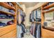 Organized walk-in closet with ample storage space and wooden shelving at 4719 Riva De Romanza St, Las Vegas, NV 89135