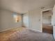 A carpeted bedroom featuring neutral walls, a window, and large closet with panel doors at 4943 Indian River Dr # 133, Las Vegas, NV 89103