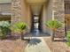 Inviting exterior of a condo building entrance with stone accents and lush landscaping at 4943 Indian River Dr # 133, Las Vegas, NV 89103