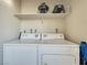 A laundry room featuring a full size washer and dryer, plus extra shelf storage at 4943 Indian River Dr # 133, Las Vegas, NV 89103