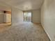Bright living room with neutral carpet and sliding glass doors to the patio at 4943 Indian River Dr # 133, Las Vegas, NV 89103