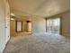 Bright and open-concept living room with carpet flooring and access to the kitchen at 4943 Indian River Dr # 133, Las Vegas, NV 89103