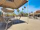 Relaxing poolside shaded lounge area features tables and chairs for enjoying the outdoor space at 4943 Indian River Dr # 133, Las Vegas, NV 89103