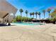 Inviting community pool area with mature palm trees and lounge seating provides a tranquil retreat at 4943 Indian River Dr # 133, Las Vegas, NV 89103