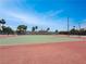 A private Tennis Court painted with green and red surfaces under a bright sky at 4943 Indian River Dr # 133, Las Vegas, NV 89103