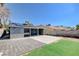 View of the backyard showing the large patio area, privacy fence, and small grass area at 5417 Eastbrook Dr, Las Vegas, NV 89142