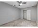 This bedroom features neutral walls, carpeted floors, ceiling fan, and closet with doors at 5417 Eastbrook Dr, Las Vegas, NV 89142