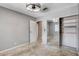 This bedroom features neutral walls, carpeted floors, modern ceiling fan, and closet with mirrored sliding doors at 5417 Eastbrook Dr, Las Vegas, NV 89142