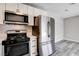 Updated kitchen featuring a gas oven range, microwave, and stainless steel fridge at 5417 Eastbrook Dr, Las Vegas, NV 89142