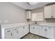Bright kitchen features white cabinets and stone countertops, with a window view over the sink at 5417 Eastbrook Dr, Las Vegas, NV 89142
