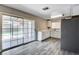 Bright kitchen features white cabinets, sleek black hardware, stainless steel refrigerator, and sliding door access to backyard at 5417 Eastbrook Dr, Las Vegas, NV 89142