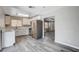 Kitchen featuring white cabinets, stainless appliances, vinyl wood floors, and natural light at 5417 Eastbrook Dr, Las Vegas, NV 89142