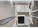 This laundry room is equipped with cabinets, washer, dryer, and shelving at 5417 Eastbrook Dr, Las Vegas, NV 89142