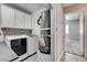 This laundry room is equipped with cabinets, washer, dryer, and water heater at 5417 Eastbrook Dr, Las Vegas, NV 89142
