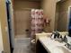 Bathroom featuring a tub with fairy curtain, a sink with marble counter and neutral tile flooring at 6454 Mount Palomar Ave, Las Vegas, NV 89139