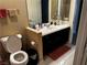 Bathroom featuring a black vanity, neutral walls, a toilet, and neutral tile flooring at 6454 Mount Palomar Ave, Las Vegas, NV 89139