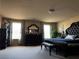 Spacious bedroom featuring a large bed, a dark wood dresser and light gray carpet flooring at 6454 Mount Palomar Ave, Las Vegas, NV 89139