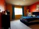 Bright bedroom featuring colorful walls, a large window with blue curtains and a blue bed at 6454 Mount Palomar Ave, Las Vegas, NV 89139