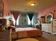 Bright bedroom featuring colorful walls, two large windows and pink bedding at 6454 Mount Palomar Ave, Las Vegas, NV 89139