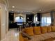 Open-concept kitchen with dark cabinets, a breakfast bar, and modern lighting at 6454 Mount Palomar Ave, Las Vegas, NV 89139