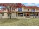 Backyard view of beige home with patio and green grass at 671 Bourbon St, Pahrump, NV 89048