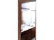 Bathroom featuring wood cabinets, broad mirror, and modern lighting at 671 Bourbon St, Pahrump, NV 89048
