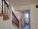 View of tiled entryway, stairway, and door to bathroom at 671 Bourbon St, Pahrump, NV 89048