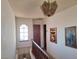 Hallway with art leading to the upstairs featuring a large window at 671 Bourbon St, Pahrump, NV 89048