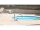 Hot tub featuring a pool deck and metal support bars for accessibility at 671 Bourbon St, Pahrump, NV 89048