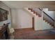 Carpeted living room with decorative fireplace and wooden staircase at 671 Bourbon St, Pahrump, NV 89048