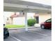 Carport for parking cars near a two-story building with green grass at 671 Bourbon St, Pahrump, NV 89048