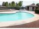 Community pool featuring lounge chairs, shade, and a hot tub at 671 Bourbon St, Pahrump, NV 89048