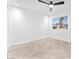 Bright bedroom with tile floors, ceiling fan and a large window showcasing the neighborhood at 6717 Sheffield Dr, Las Vegas, NV 89108