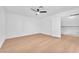 This bedroom boasts sleek wood floors, a modern ceiling fan, and an adjacent doorway at 6717 Sheffield Dr, Las Vegas, NV 89108