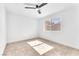 Well-lit bedroom with tile floors, ceiling fan and a window at 6717 Sheffield Dr, Las Vegas, NV 89108