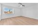 Bright bedroom features light wood floors, a ceiling fan, and a large window offering outdoor views at 6717 Sheffield Dr, Las Vegas, NV 89108