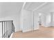 Hallway with hardwood flooring and a white walls, with a partial view of metal railing of stairs at 6717 Sheffield Dr, Las Vegas, NV 89108
