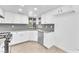 Modern kitchen featuring granite countertops, stainless steel appliances, and white cabinets at 6717 Sheffield Dr, Las Vegas, NV 89108