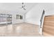 Bright living area with glass sliding doors, tile flooring and stairs to the second floor at 6717 Sheffield Dr, Las Vegas, NV 89108