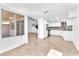 Open-concept living space featuring tile flooring, natural light, and a view of the staircase and kitchen at 6717 Sheffield Dr, Las Vegas, NV 89108