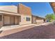 Side exterior of home with gravel landscaping, white doors, and neutral exterior paint at 6717 Sheffield Dr, Las Vegas, NV 89108